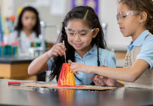 Two girls doing volcano explosion