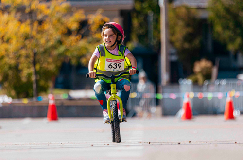 Girl gliding on balance bike